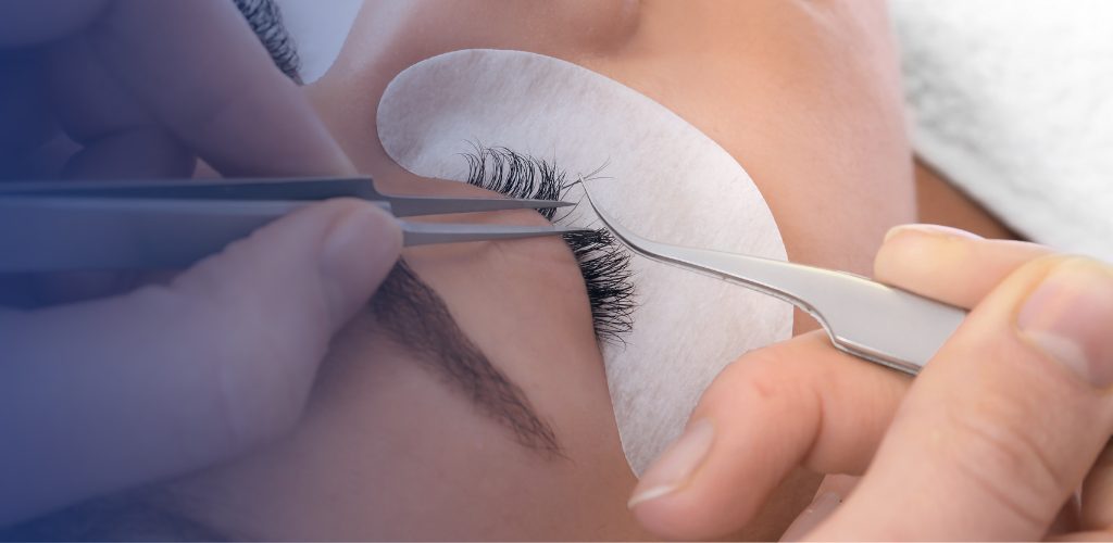 beautician hands with working tools applying false eyelashes to her customer in spa salon, beauty treatment concept.