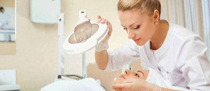 Cosmetologist is a professional with a patient in the office of a medical clinic.