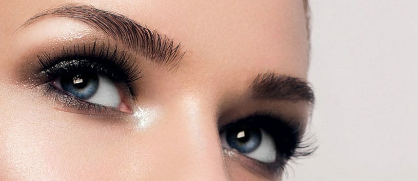 Close-up image of a woman's groomed eyebrows.