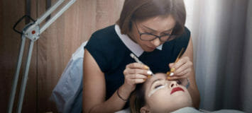 beautician applying false eyelashes to her customer, beauty treatment concept.lifestyle shot.